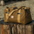 Filson Tin Cloth Duffle Bag Dark Tan on wood
