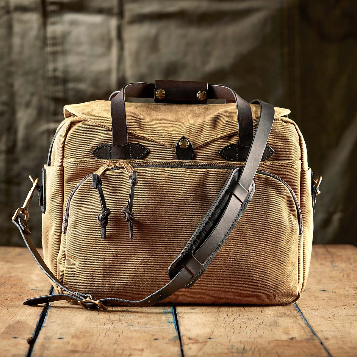 Filson Padded Computer Bag 11070258 Tan on a wooden floor