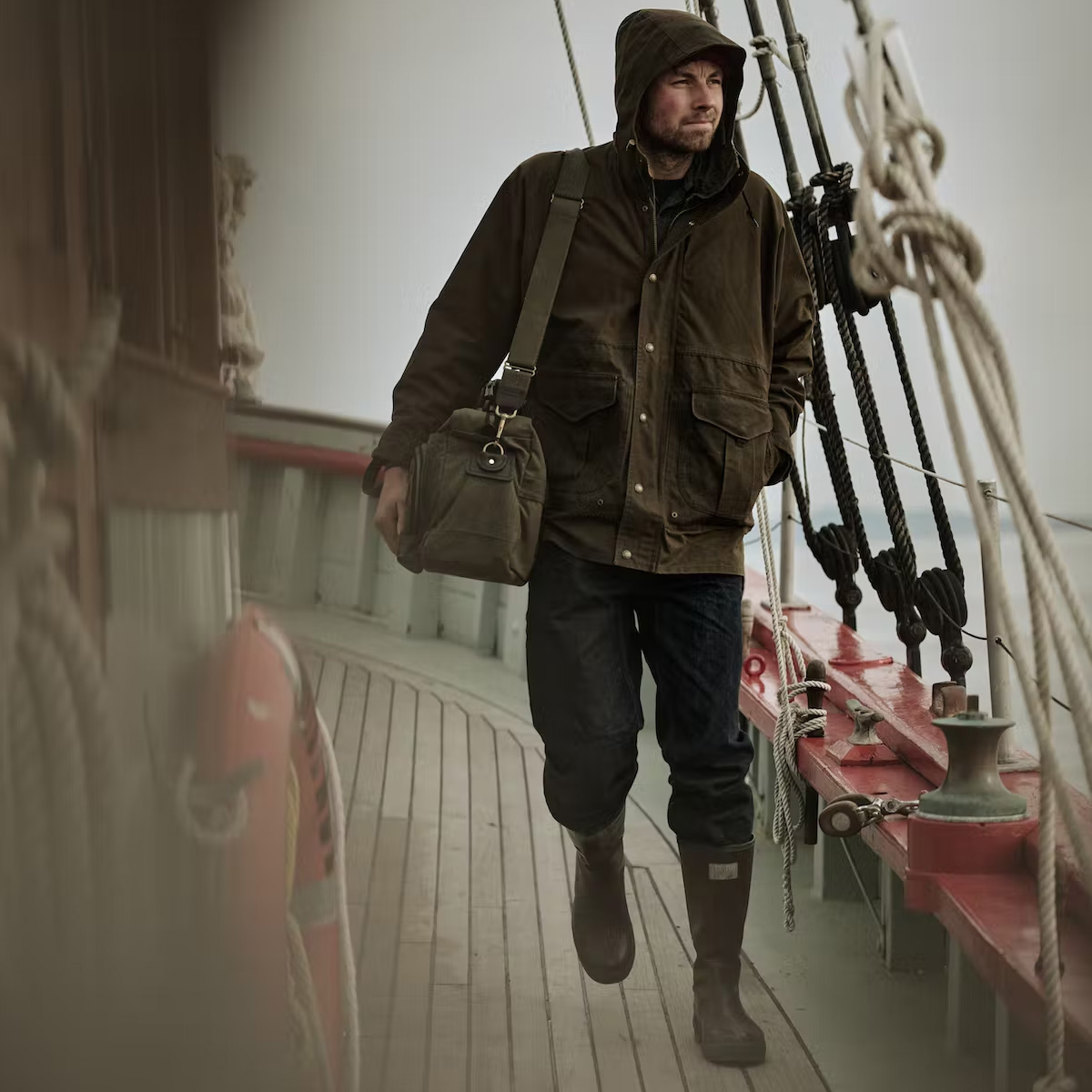 Filson All Season Rain Coat Root, een regenbestendige gevoerde jas met aangehechte capuchon en naadloze schouders