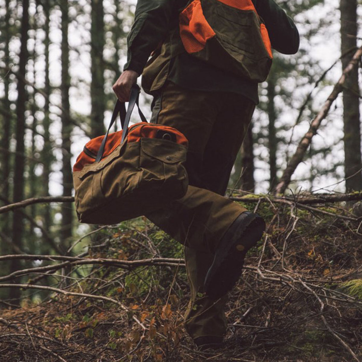 Filson Heritage Sportsman Bag Orange/Dark Tan, in the woods
